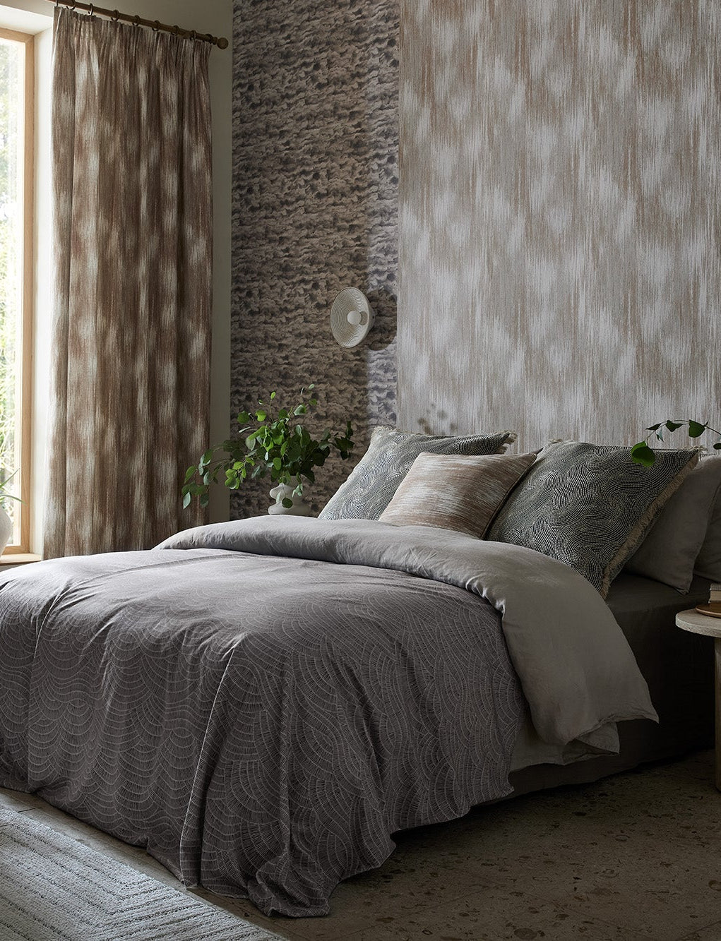 Elemental textured wallpaper in a mineral-toned bedroom